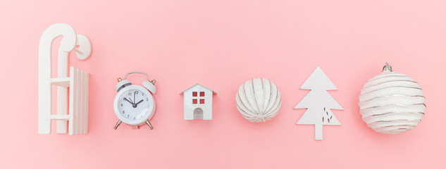 Simply minimal composition winter objects ornament sled fir tree ball alarm clock isolated pink...