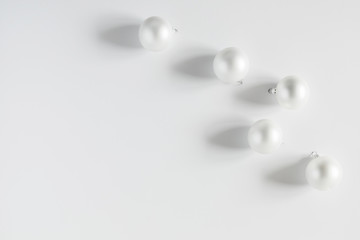 Christmas modern composition. Xmas white decorations on white background. New Year, winter concept. Flat lay, top view, copy space
