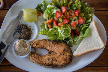 Salmon steak with fruit and vegetable salad