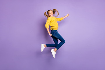 Fototapeta premium Full length photo of cheerful candid child jump enjoy fall weekends wear casual style outfit isolated over purple color background