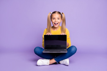 Full size photo of amazed excited child show laptop show touch screen scream wow omg sit crossed...