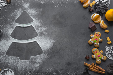 Christmas tree made from flour on a table with cookies, anise and cinnamon
