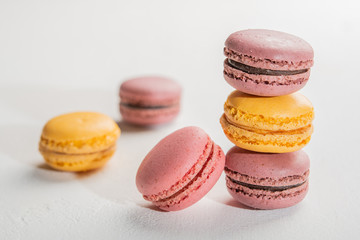 Obraz na płótnie Canvas Macarons pattern on white background. Colorful french desserts. Close up