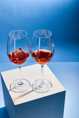 high angle view of cocktails Aperol Spritz with ice cubes in glasses on blue background