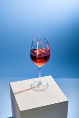 cocktail Aperol Spritz with ice cube in glass on blue background