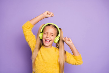 Portrait of funky crazy kid with ponytails listen music have break pause use headset sing song...