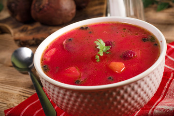 Red borscht soup in bowl.