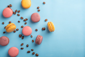 Fototapeta na wymiar Colorful French or Italian macaron stack on blue table with copy space for background. Top view