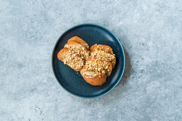 Turkish Dessert Hayrabolu with Sherbet, Tahin, Cheese and Hazelnut Powder.