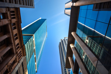 Fototapeta na wymiar Looking up perspective from Pitt street at some monumental Skyscrapers in Sydney CBD, Australia.