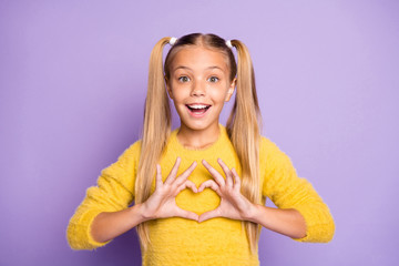 Photo of stylish trendy cheerful positive girl showing heart shape sign with emotions on face...