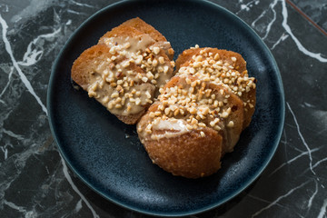 Turkish Dessert Hayrabolu with Sherbet, Tahin, Cheese and Hazelnut Powder.
