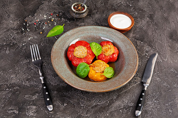 Colorful stuffed peppers with rice and minced meat on wooden background.