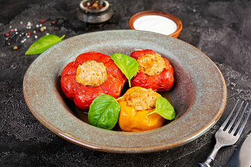 Colorful stuffed peppers with rice and minced meat on wooden background.