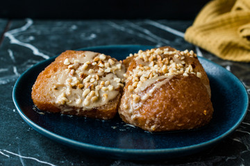 Turkish Dessert Hayrabolu with Sherbet, Tahin, Cheese and Hazelnut Powder.