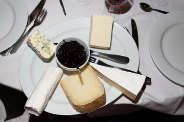 Various types of french cheese in plate with fruit jam
