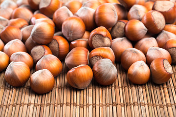 close up of hazelnuts on wooden table .