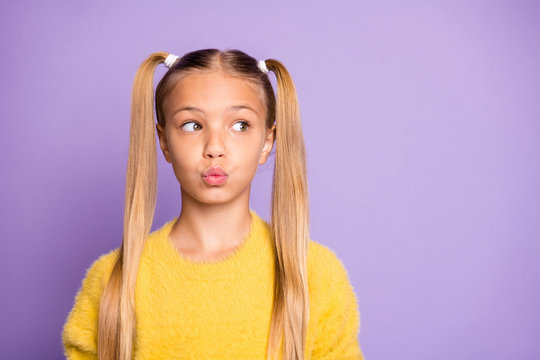Photo of girl looking into empty space with her lips pouted isolated pastel violet color background