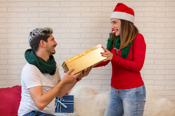 Man and woman delivering a Christmas gift box.