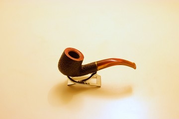 Clean wooden smoking pipe isolated on a stand after quit smoking