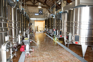 modern wine cellar with stainless steel tanks vats in Bordeaux region France