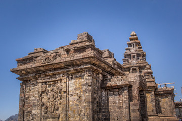 Old temple complex surrounded by mountains under beautiful blu sky