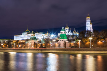 Fototapeta na wymiar Illuminated Moscow Kremlin with Grand Kremlin Palace the government residence of president of Russia. View from the embankment of Moskva river. Evening urban landscape in the blue hour