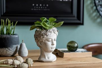 Stylish composition of interior design with modern cement sculpture pot, plants, book and elegant...