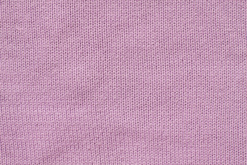 Pink woolen clothes. Knitted fabric, textile texture