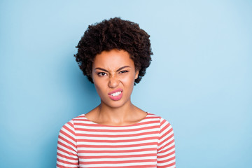Ugh. Closeup photo of pretty unhappy dark skin lady disgusted with awful eat look expressing disagreement wear striped shirt isolated blue color background - obrazy, fototapety, plakaty