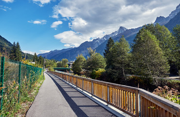 Fototapeta na wymiar Asphalt road in the Chamonix Valley. Alps, France