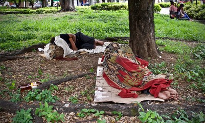 homeless man sleeping in the park