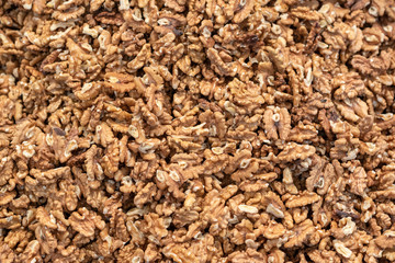 Peeled walnuts background, organic foods in market.