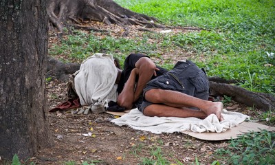 homeless man sleeping in the park