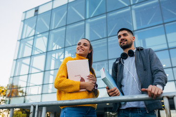 friends students outdoors talking in campus