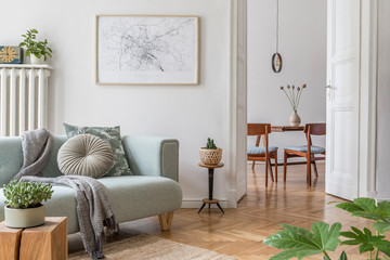 Stylish scandinavian living room and dining room with design mint sofa, mock up poster map, plants...