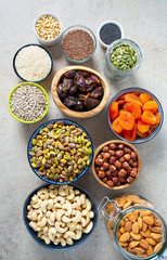fresh nuts and dried fruis on granite surface
