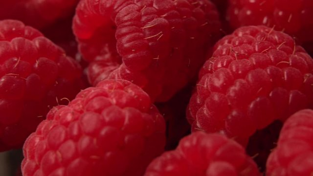 Raspberries super close up 4K stock footage. Detail of Raspberries . Macro trucking shot , healthy food concept 