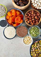 fresh nuts and dried fruis on granite surface