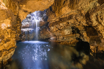 Smoo Cave, a large combined sea and freshwater cave with a waterfall in Durness, Sutherland,...