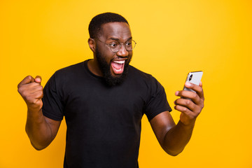 Photo of overjoyed crazy casual brown haired bearded man in eye glasses t-shirt rejoicing in...