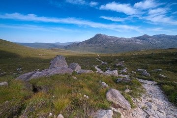 Hiking the Torridon Hills, made of some of the oldest rocks in the world and among the most spectacular peaks in the British Isles. Highlands of Scotland.