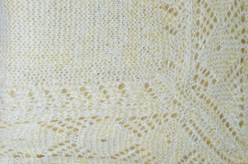 fragment of knitted warm shawl close up background