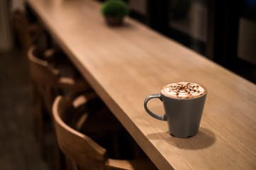 hot chocolate in a blue cup, put on a wooden table