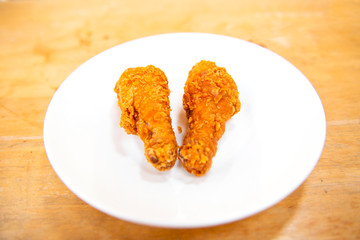Delicious chicken fried is placed in white dish on a wood table, good for healthy food