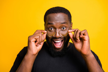 Close up photo of excited funny black man wearing eye glasses for the first time seeing his friends...