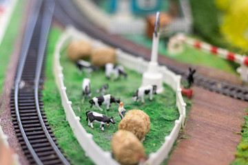 Pasture cows with a shepherd and hay. Hobby part of a miniature railway layout