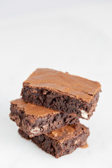 brownies chocolate three stacked on white background