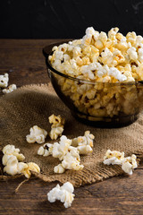 Air salty popcorn.A bowl of popcorn on a wooden table.Salt popcorn on the wooden background .  With space for text.Top view.popcorn texture.Chees .