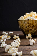 Air salty popcorn.A bowl of popcorn on a wooden table.Salt popcorn on the wooden background .  With space for text.Top view.popcorn texture.Chees .